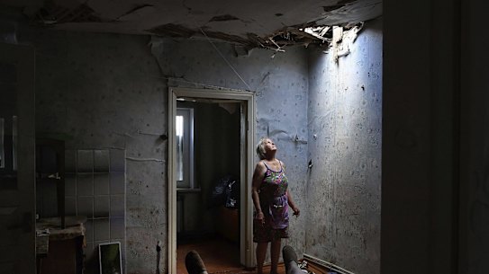 Zoya Shaposhnik looks up at the hole in her ceiling after a missile strike near their home in Krasnohorivka in June 2022. 