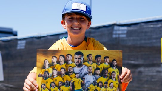 A young fan shows off his poster.