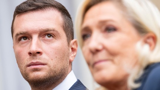 Jordan Bardella, president of France’s National Rally, left, wirth party leader Marine Le Pen.