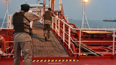 Two armed members of Iran's Revolutionary Guard inspect the British-flagged oil tanker Stena Impero in July. Tensions have flared again after the assassination of Qassem Soleimani by the US.