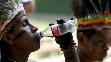 A representative of the Huitoto and Ticuna indigenous communities drinks Coke in Leticia, on Colombia's Amazon river border with Brazil and Peru.  A doctor working with the Ticunas has tested positive for coronavirus.