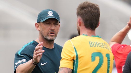 Tony Popovic greets Cameron Burgess after the match.