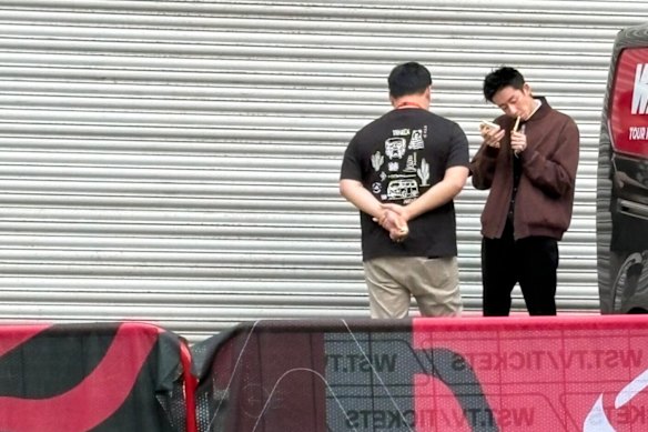 Wu Yize lights a cigarette out the back of the Crucible Theatre.