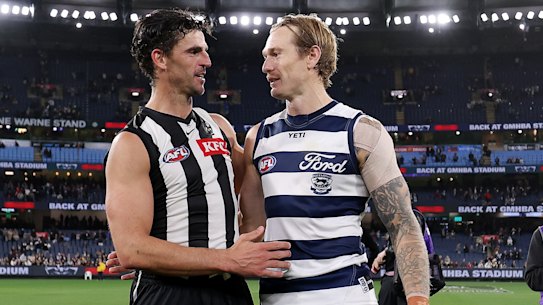 Scott Pendlebury of the Magpies and Tom Stewart of the Cats embrace after the final siren.