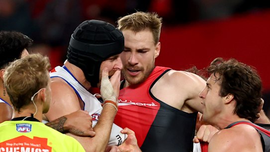 Tristan Xerri (in helmet) and Andrew McGrath clash at Marvel Stadium on Saturday night.