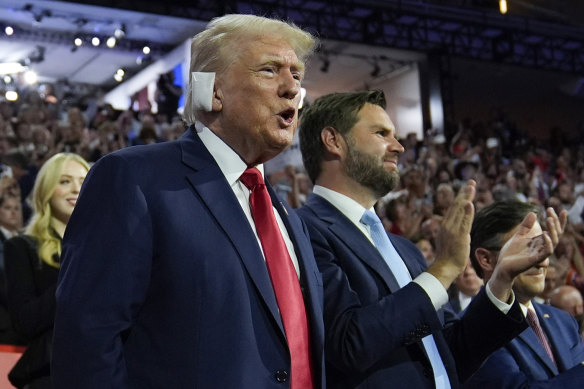 Republican presidential candidate Donald Trump and his vice-presidential candidate J.D. Vance applauding the speakers at the RNC.
