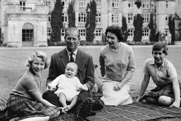 Andrew as a baby in Prince Philip’s lap in a family portrait at Balmoral Castle, 1960 (from left, Princess Anne, Queen Elizabeth and Prince Charles).