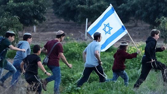 Right-wing Israeli settlers walk in the direction of the Israel-Gaza border during a rally near the Kibbutz Kfar Aza in southern Israel on February 5, 2026.