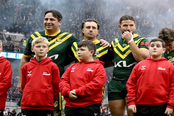 Daniel Jarvis links arms with Munster during the Australian national anthem.