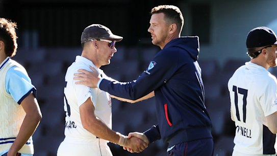 Josh Hazlewood shakes hands with Scott Boland after their Sheffield Shield match at the SCG last summer.