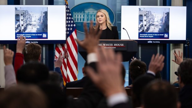 White House press secretary Karoline Leavitt displays a Fox News clip of damage in Gaza during a news conference.