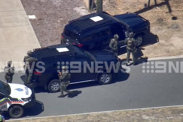 Police gathering outside a home on Teague Street. 