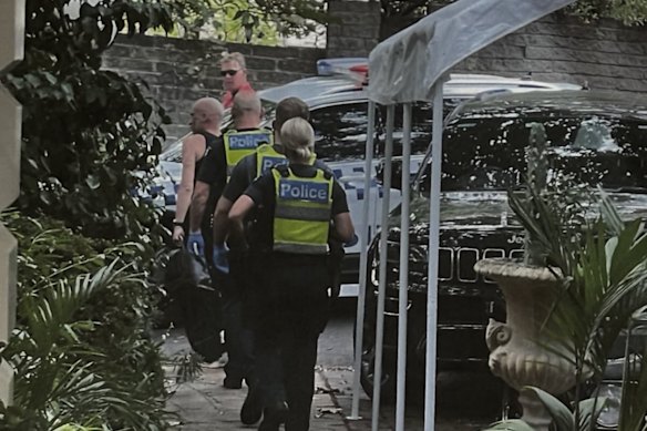 Maurice Terzini being taken away by police after a dispute with his wife Emma. 
