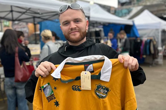Nick Christie proudly holding a vintage 2003 Wallabies World Cup jersey in Melbourne