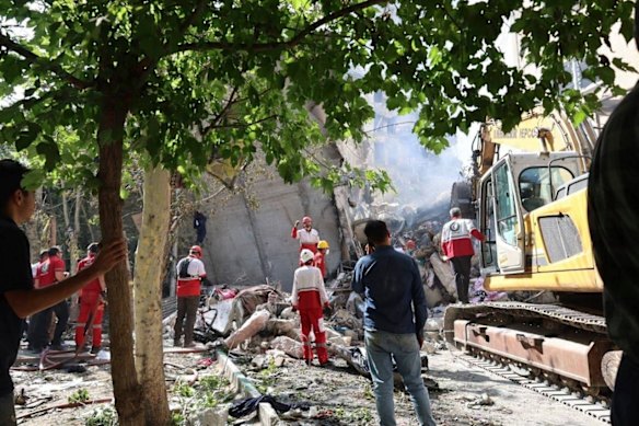 Red Crescent Society rescuers work at the scene of an explosion after an Israeli strike in Tehran.