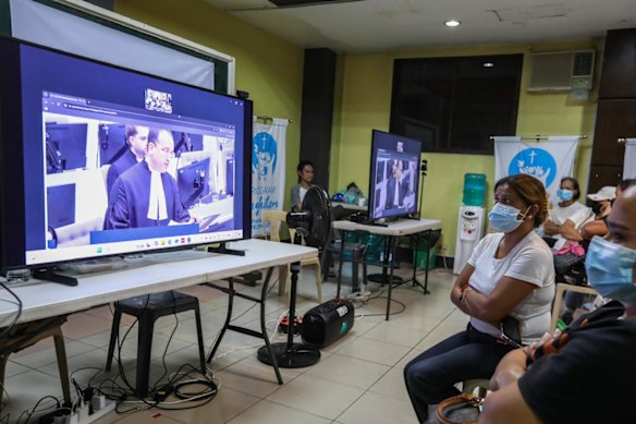 Family members of people killed during Duterte’s war on drugs watch as his defence lawyer, Nicholas Kaufman, speaks at The Hague. 