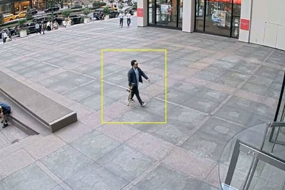 The man believed to be the gunman walking into the building in New York City.