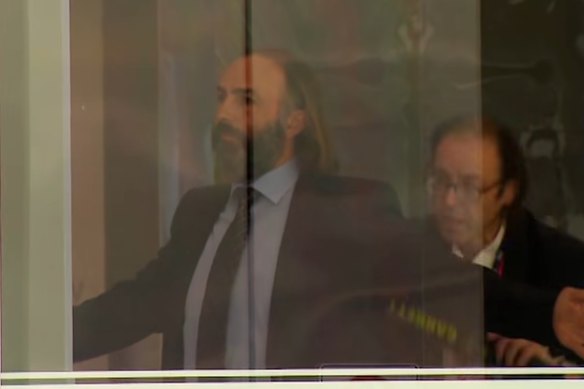 Andrew Marshall (left) is scanned by a security officer at the County Court of Victoria on November 25.