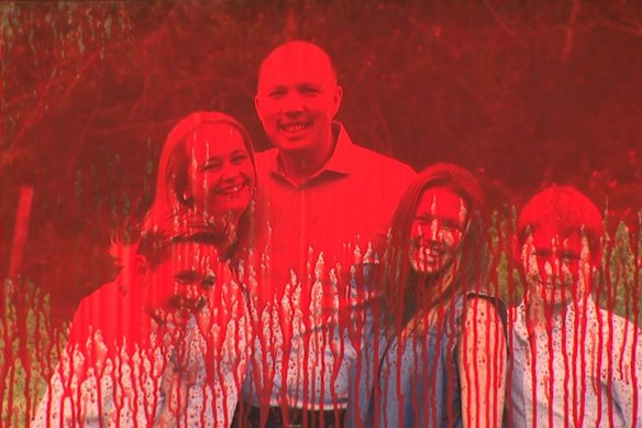 Red paint was splashed on a portrait of Dutton’s family at the office entrance.