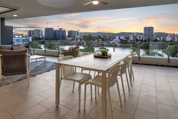 The balcony offers panoramic views of Mount Coot-tha and the Brisbane River.