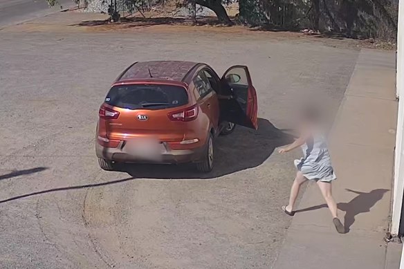 A woman rushes to her car after it is allegedly stolen by a 15-year-old boy in Kalgoorlie while her son is inside.