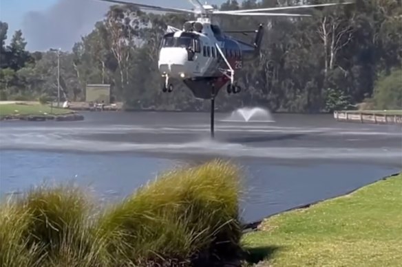Firefighters continue work to control the bushfire burning in the Worrowing Heights area, north of Sanctuary Point.
