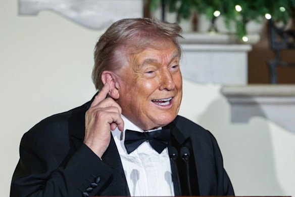 Stop laughing, this is serious ... US President Donald Trump at the Congressional Ball in the grand foyer of the White House on Thursday.