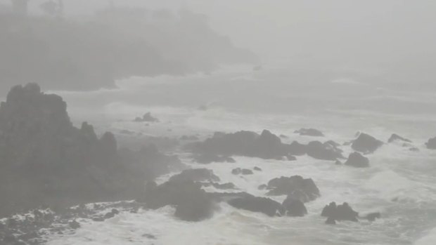 Heavy rain and high wind lashes North Queensland as the remnants of the former cyclone Koji hammer the coast.