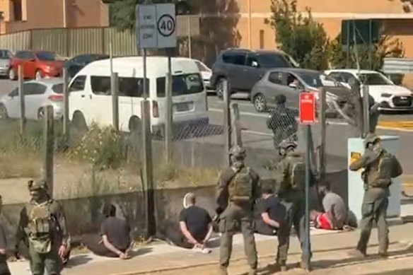 The men lined up after their arrest.