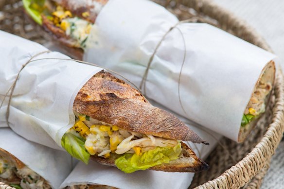 Chicken and corn baguettes, wrapped and packed for a picnic.