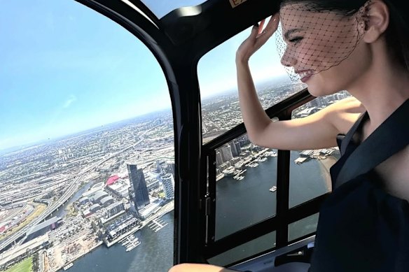 Comedian influencer Lucia Hawley flies to Flemington for the Melbourne Cup Carnival on a Microflite helicopter last year.
