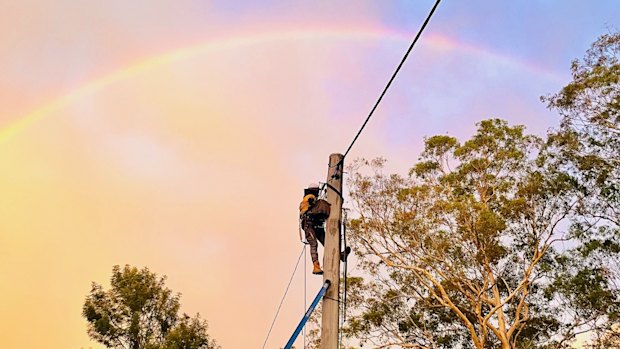 An Energex technician working to restore power after a storm on the Gold Coast.