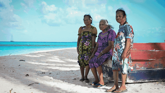  Castle Bravo survivors (from left) Susan Ned, Kathy Joel and Mina Titus on a beach on Mejatto Island in the Marshall Islands. Greenpeace flagship, the Rainbow Warrior III, is in the background.