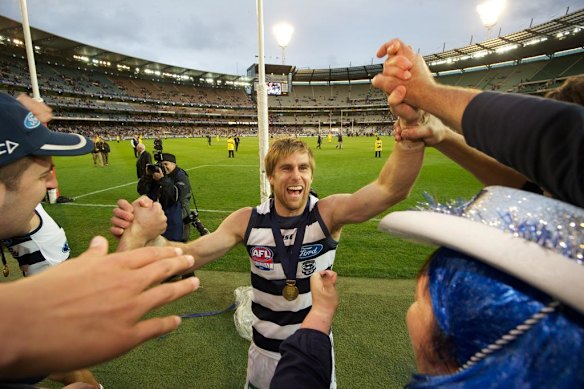 Tom Lonergan and Geelong fans celebrate winning the 2011 AFL grand final over Collingwood.