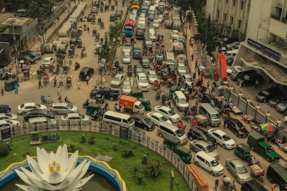 Traffic in the capital, Dhaka, wends its way past Shapla Square, which showcases a sculpture of a water-lily (or shapla), Bangladesh’s national flower.  