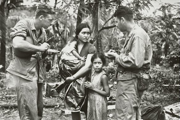 War reporters speak to a Chamorran woman on Guam, in the Northern Mariana Islands, in 1944. The Chamorrans are the islands’ Indigenous people.
