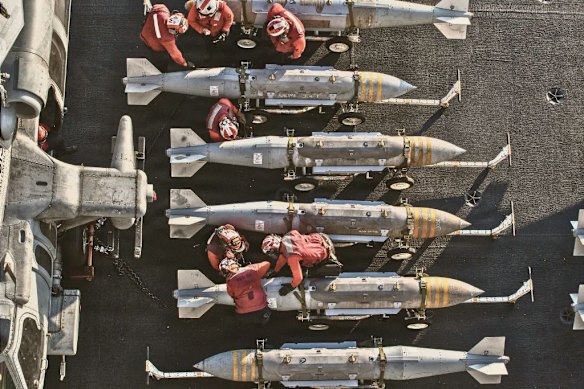 US sailors prepare to stage ordnance on the flight deck of Nimitz-class aircraft carrier USS Abraham Lincoln during Operation Epic Fury on February 28.