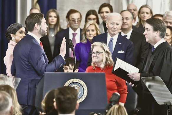 Supreme Court Justice Brett Kavanaugh (far right) administers the vice presidential oath of office to Vance as Vance’s mother Bev (in the red top) watches, on January 20, 2025 in Washington, DC.  

