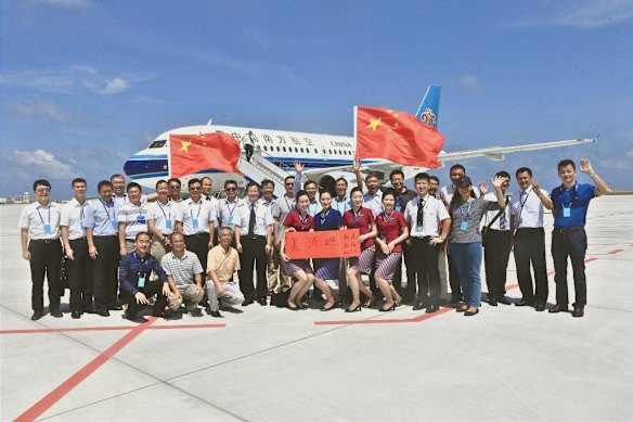 Celebrations as a China Southern Airlines flight lands on Meiji Reef, also known as Mischief Reef, in the Spratlys on July 13, 2016. On July 12, an international arbitration court had ruled in favour of the Philippines and against China over its claims to the islands.