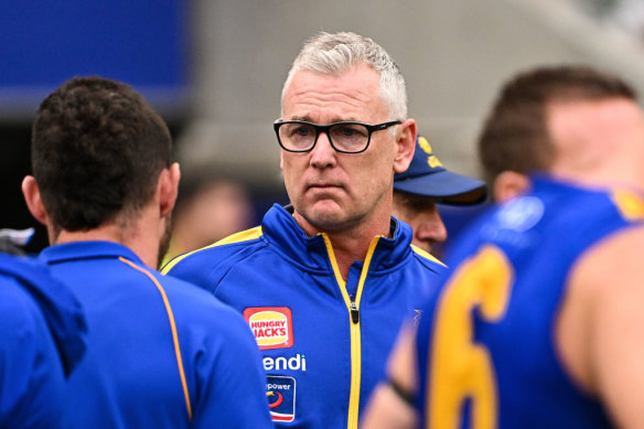 Simpson addresses his players at the break during the round 12 match against the Roos. 