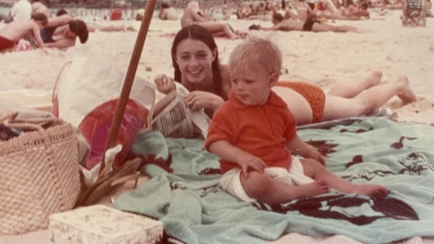Justin Scarr as a baby with his mum at the beach in 1971.