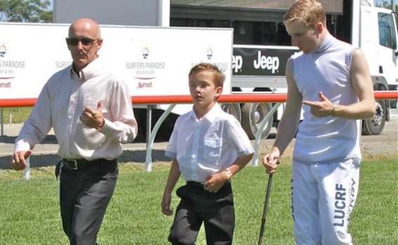 Jeff and Zac Lloyd walk the Gold Coast track with Nathan Berry in 2014 before his win on Unencumbered in the Magic Millions Classic.