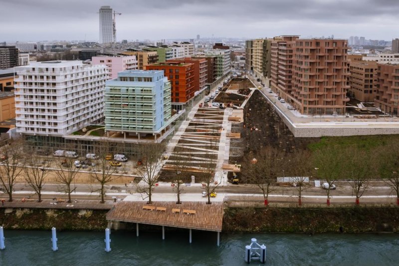 The Paris 2024 athletes village on the edge of the Seine River in Saint-Denis, which has 3000 new apartments above office space for delegations that will be converted to retail and other commercial space after the Games. 