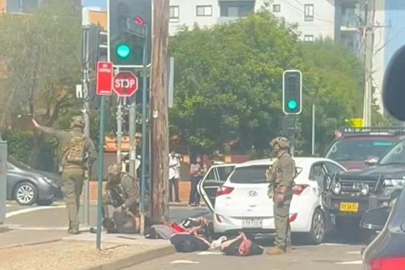 Heavily armed police could be seen standing over at least five men.