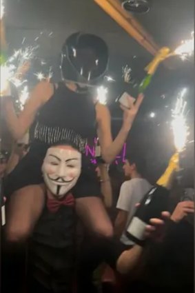 In a photograph of the bar reportedly taken by a survivor before the fire broke out and sent to France’s BFMTV, a woman can be seen on the shoulders of a man, holding bottles in her hands with sparklers attached.