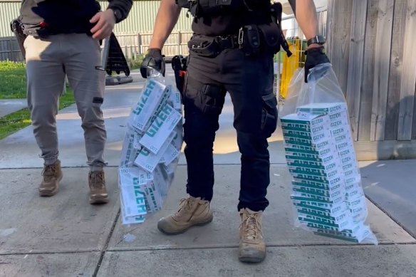 Police detectives earlier this month after arresting four adults who allegedly orchestrated a network of child offenders to steal more than $2 million worth of cigarettes and cash from service stations and supermarkets across Melbourne.