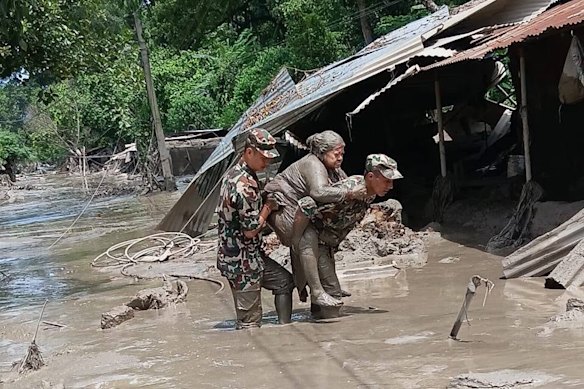Nepal military service members rescue people from the deadly flash floods.