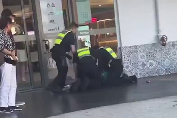 Police officers tackle a person at Northland shopping centre in Preston after a brawl involving knives broke out there earlier this year.