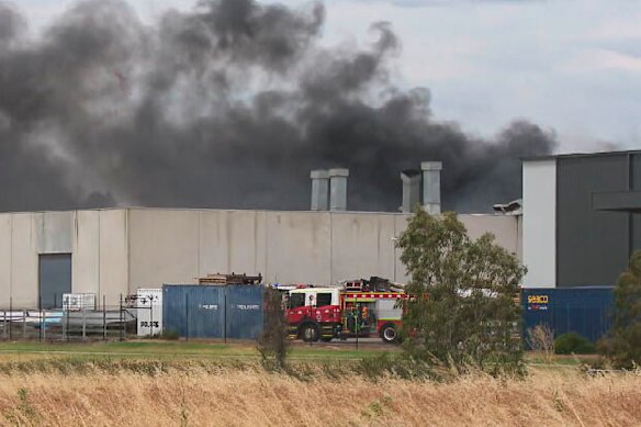 Fire crews battle a factory fire in Derrimut on Friday.