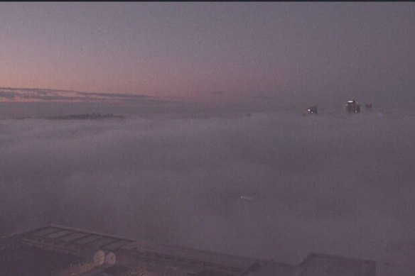 The sun rises as a heavy blanket of fog covers the Sydney CBD on Tuesday morning.